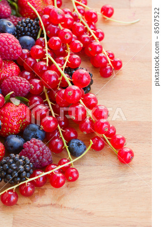 pile of fresh red berries on table 8507522