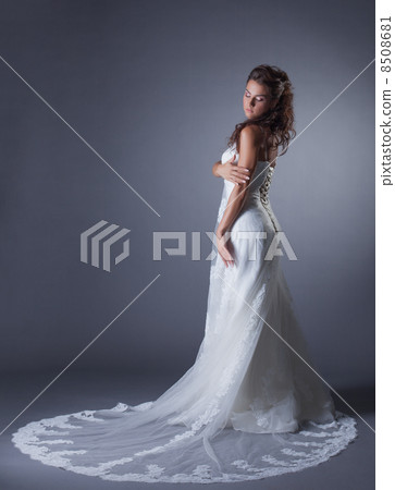 Slender brunette posing in stylish wedding dress 8508681