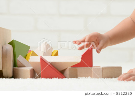Baby's hand playing with building blocks 8512280