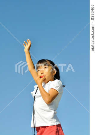 A girl playing a whistle 8523465