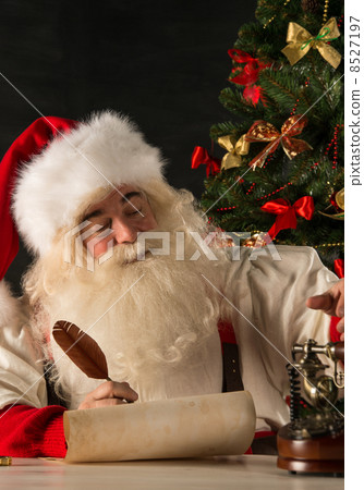 Portrait of Santa Claus answering Christmas letters 8527197