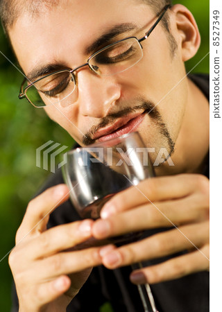 Handsome young man drinking red wine Handsome young man drinking red wine 8527349