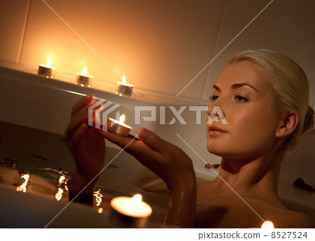 Lovely young woman relaxing in bathroom Lovely young woman relaxing in bathroom 8527524