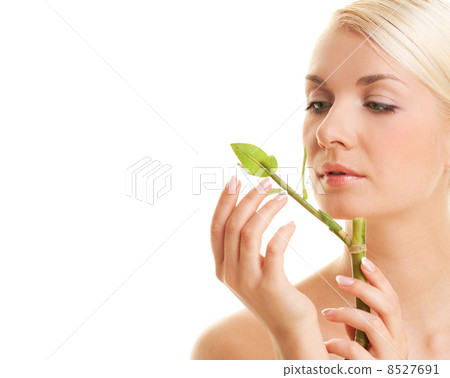 Beautiful young woman with a bamboo plant 8527691