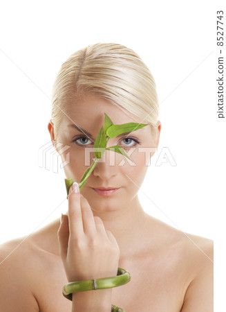 Beautiful young woman with a bamboo plant .... 8527743
