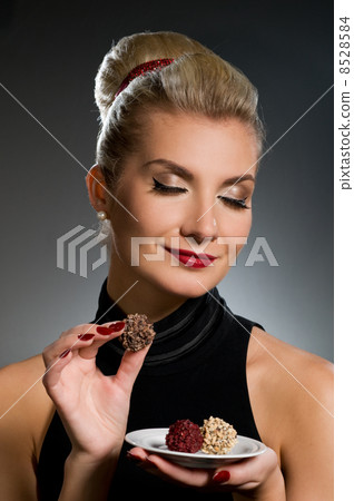 Charming lady tasting chocolate 8528584