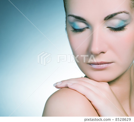 Beautiful young woman close-up portrait (toned in blue) 8528629