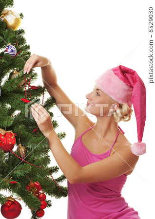 Santa girl decorating the christmas tree 8529030