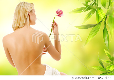 Beautiful woman with naked back over green abstract background Beautiful woman with naked back over green abstract background 8529148