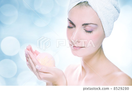 Beautiful young woman with aroma bath ball over abstract blurred Beautiful young woman with aroma bath ball over abstract blurred 8529280