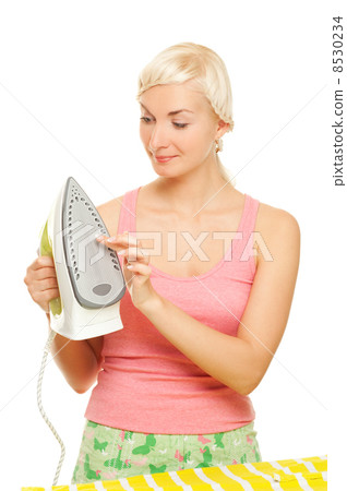 Beautiful woman ironing clothes. Isolated on white background Beautiful woman ironing clothes. Isolated on white background 8530234