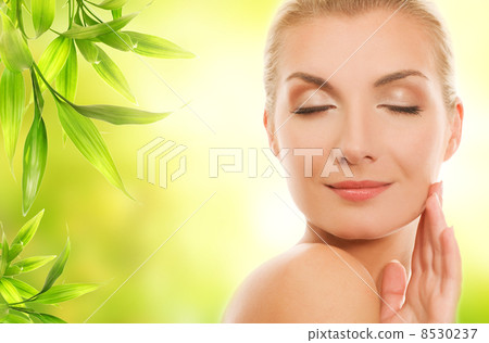 Beautiful young woman applying organic cosmetics to her skin Beautiful young woman applying organic cosmetics to her skin 8530237