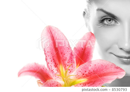Beautiful young woman with pink lily close-up portrait. Isolated 8530793