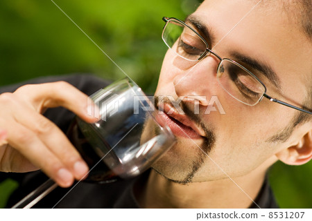 Handsome young man drinking red wine Handsome young man drinking red wine 8531207