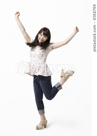 A woman who raises his hands and takes a pose A woman who raises his hands and takes a pose 8568769