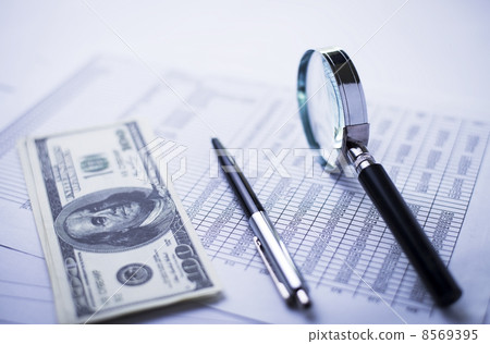 Dollars with a magnifying glass, pen and report Dollars with a magnifying glass, pen and report 8569395