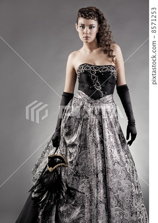 Woman wearing masquerade costume 8571253