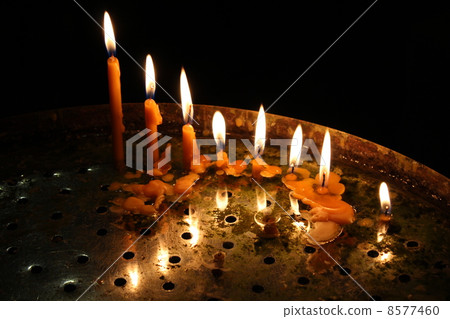 row of bright burning church candles 8577460