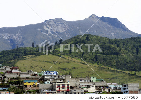 Upper edge of the city of Quito with active volcano Guagua Pichincha in background 8577586