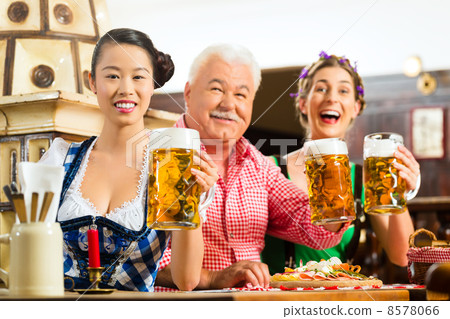 friends drinking beer in Bavarian pub 8578066