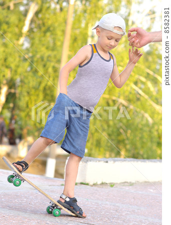 Boy Child Training Skateboard jumping Outdoor Summer Sport with nature on background Boy Child Training Skateboard jumping Outdoor Summer Sport with nature on background 8582381