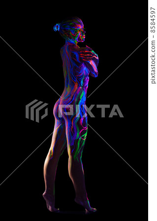 Slim nude model with glowing pattern on body 8584597