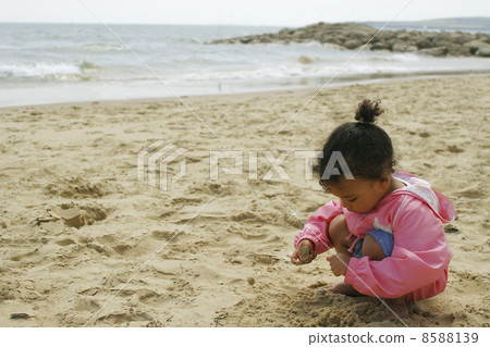 Girl Playing on Sandy Beach Girl Playing on Sandy Beach 8588139