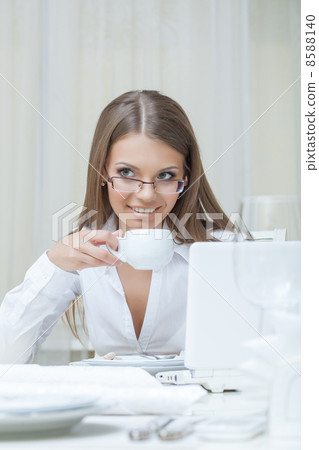 Business woman drinking coffee in restaurant Business woman drinking coffee in restaurant 8588140