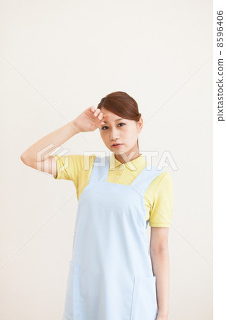 Nurse touching forehead Nurse touching forehead 8596406