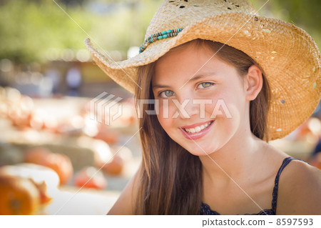 Preteen Girl Portrait Wearing Cowboy Hat at Pumpkin Patch Preteen Girl Portrait Wearing Cowboy Hat at Pumpkin Patch 8597593