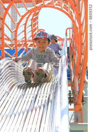 A child sliding on a slide A child sliding on a slide 8609352