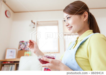 Young female caregiver meal assistance 8609414