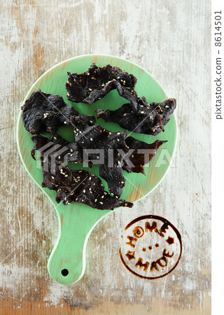 jerky beef - homemade dry cured spiced meat with stamp on wood 8614501