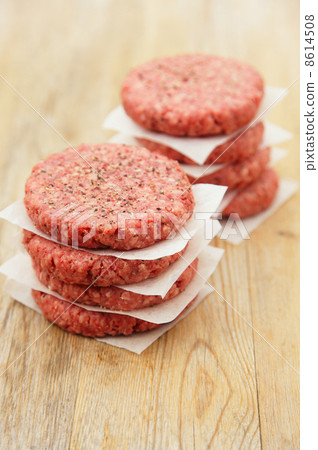 Raw burgers for hamburgers, in a pile 8614508