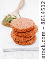 Raw burgers for hamburgers, in a pile 8614512