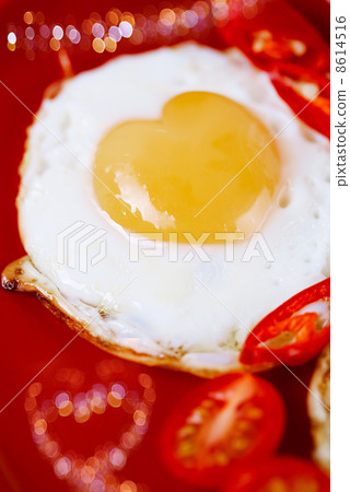 fried egg with heart shape yolks and heart shaped bokeh 8614516
