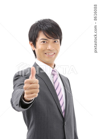 A businessman doing a thumbs up 8616088