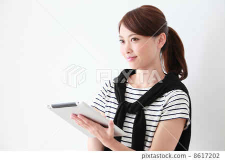 A woman using a tablet PC A woman using a tablet PC 8617202