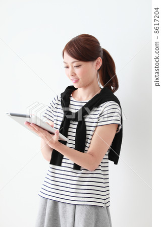 A woman using a tablet PC A woman using a tablet PC 8617204