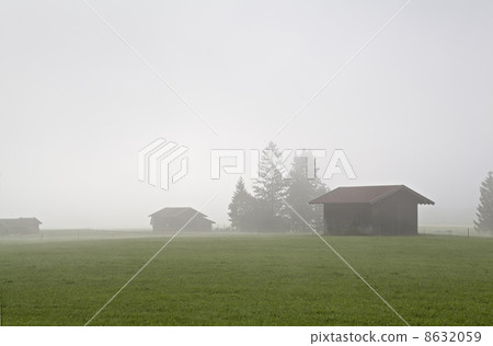 wooden huts in fog 8632059