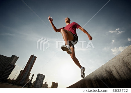 hispanic man running and jumping from a wall hispanic man running and jumping from a wall 8632722