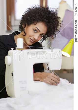 Fashion designer with sewing machine Fashion designer with sewing machine 8632813