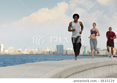 three friends doing sport activities near the sea three friends doing sport activities near the sea 8633124