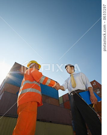 businessman and manual worker with cargo containers 8633197