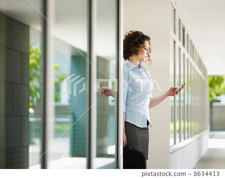 woman reading emails outdoor 8634413