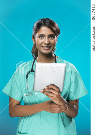 Portrait of a Female indian, doctor holding a digital tablet. 8637416