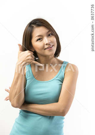 Portrait of a happy Asian woman making call me gesture 8637736