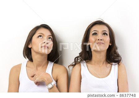 Two happy Asian women looking up 8637748