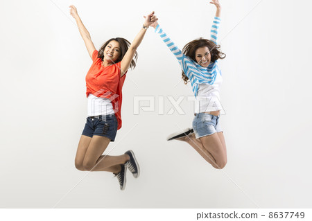 Two Asian women jumping 8637749