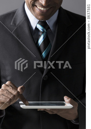 Closeup of an Indian man with a tablet computer. Closeup of an Indian man with a tablet computer. 8637881